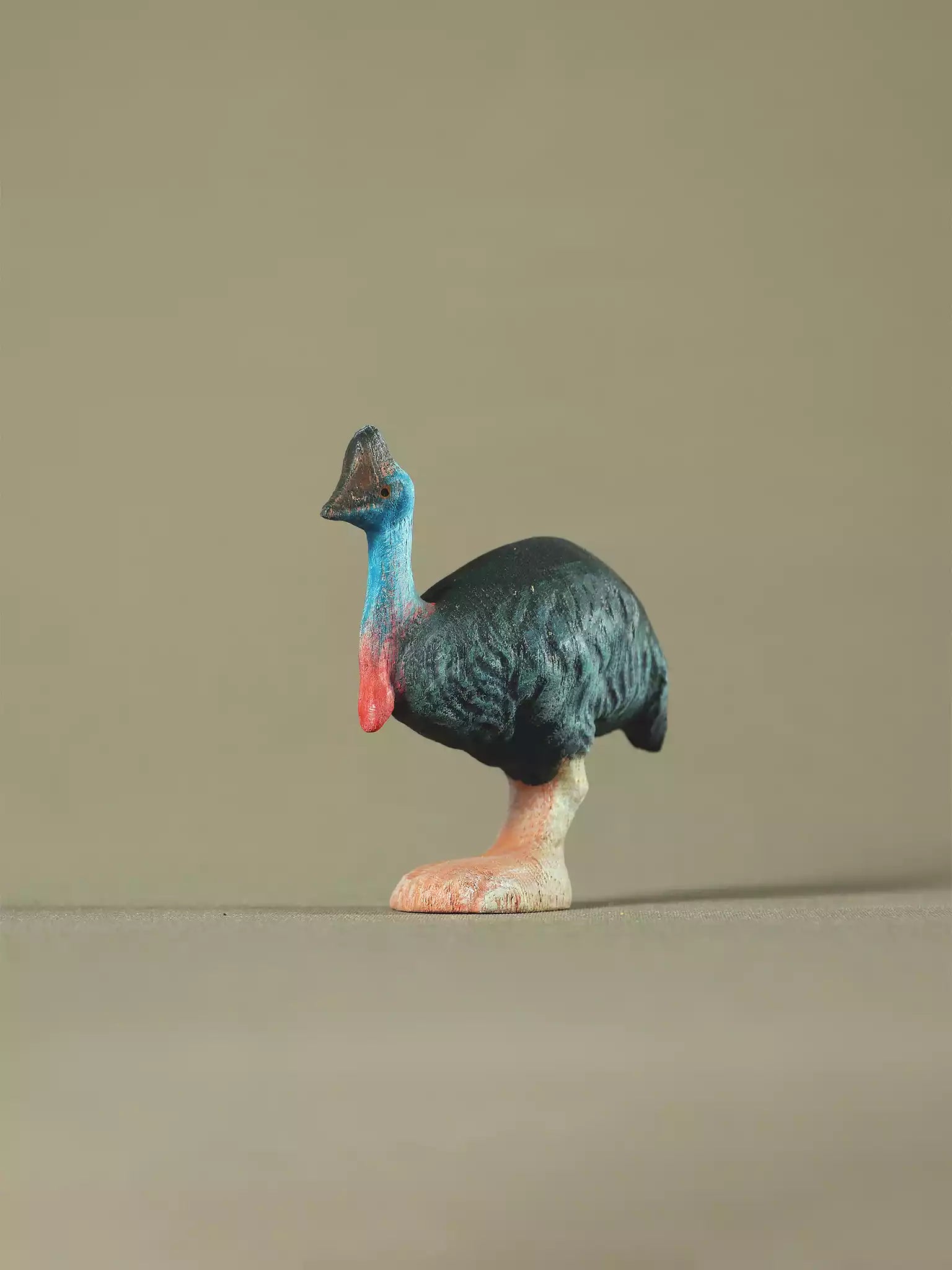 Hand-painted wooden cassowary toy with blue neck and black body, eco-friendly Montessori and Waldorf-inspired figure.