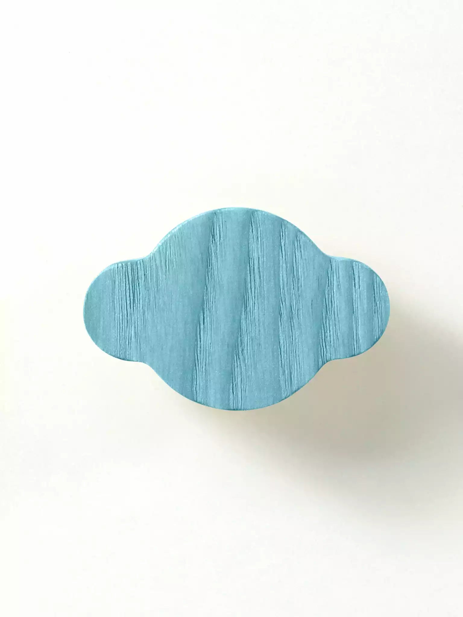 Solid wood cabinet handle with natural grain on white background