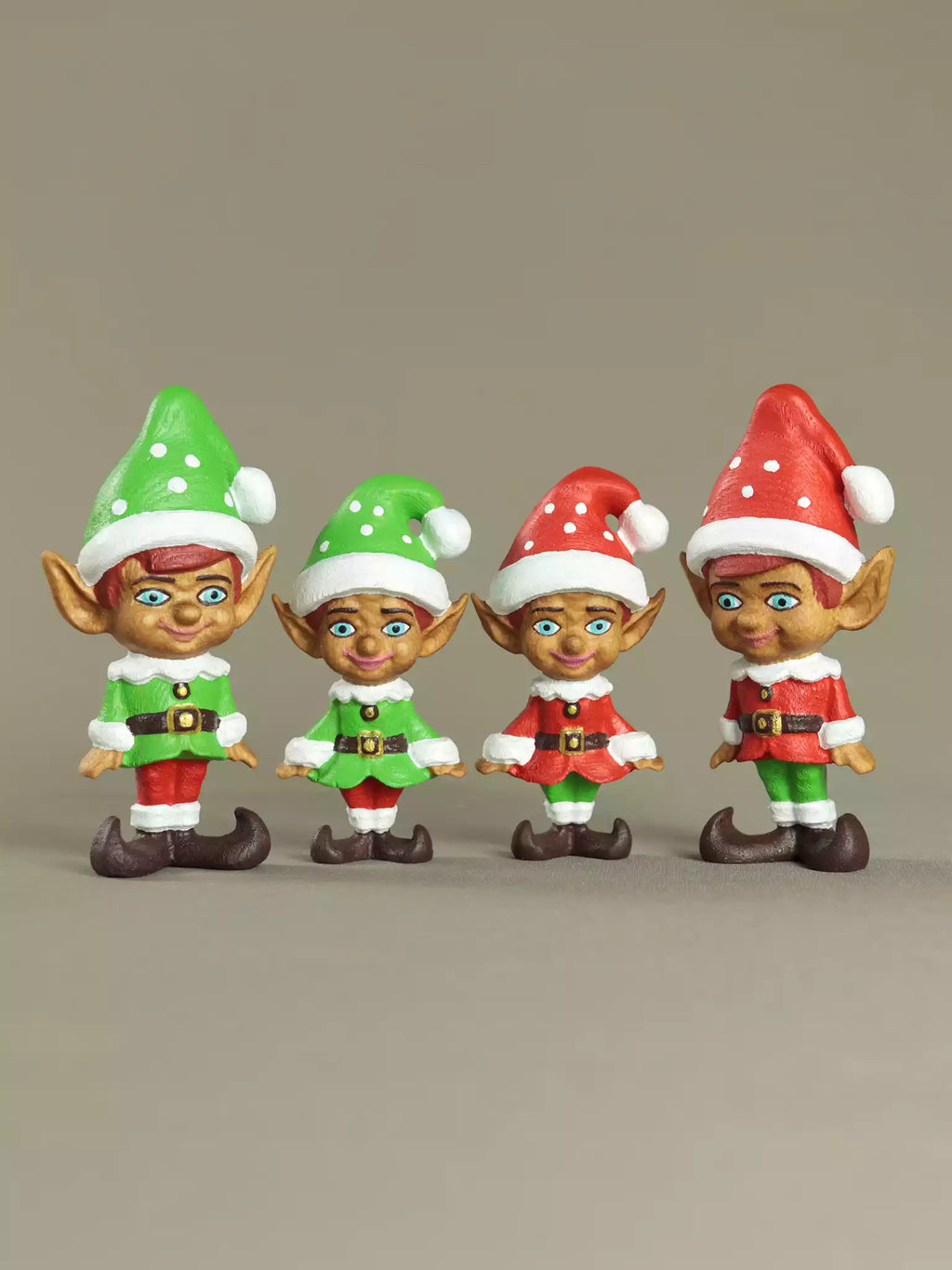Four Christmas elves in festive outfits on a beige background