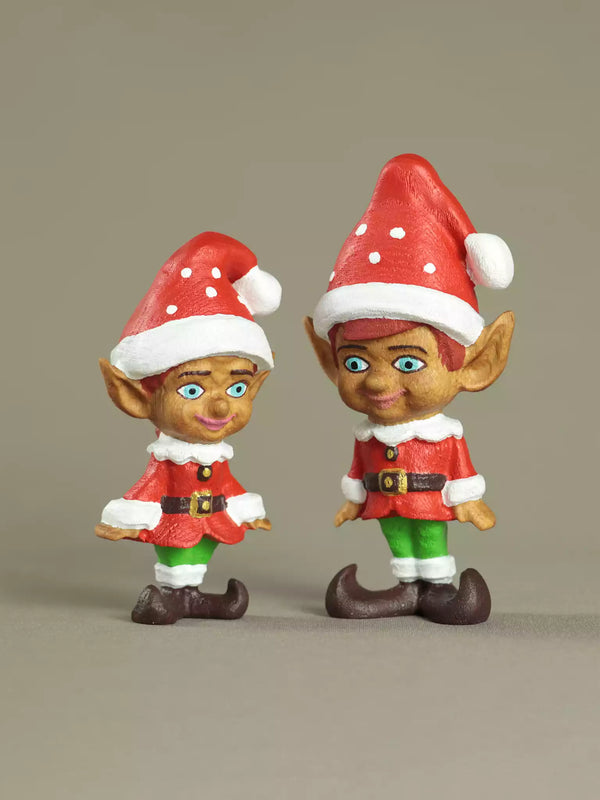 Two Christmas elves with red hats and outfits on a beige background