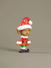 Christmas elf figurine with a red hat and outfit on a beige background