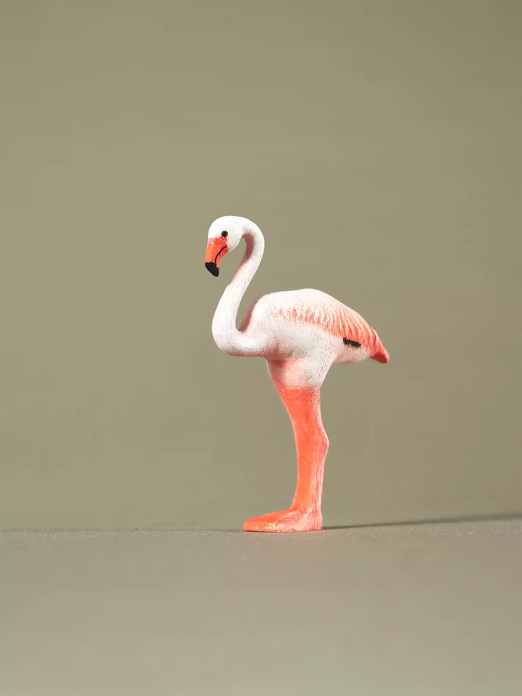 Sustainable wooden flamingo figurine for educational play, featuring detailed carving and non-toxic paints.
