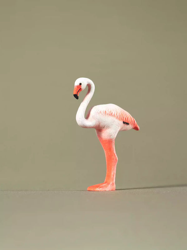 Sustainable wooden flamingo figurine for educational play, featuring detailed carving and non-toxic paints.