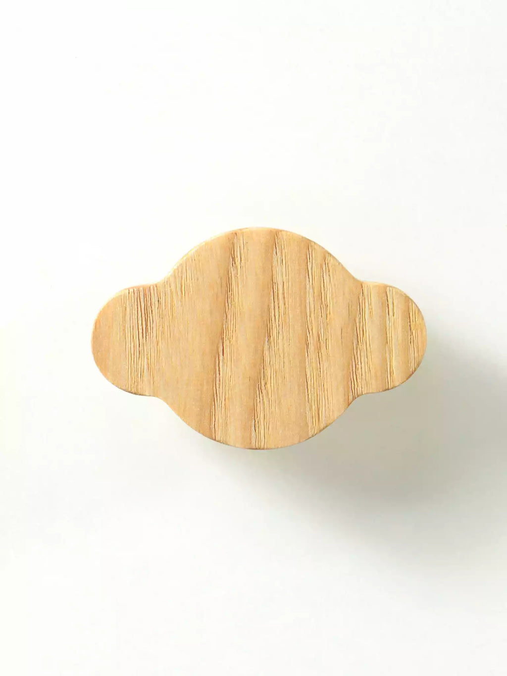 Natural wood cabinet handle with organic silhouette

