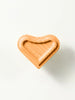Heart-shaped wooden furniture knob photographed on white background