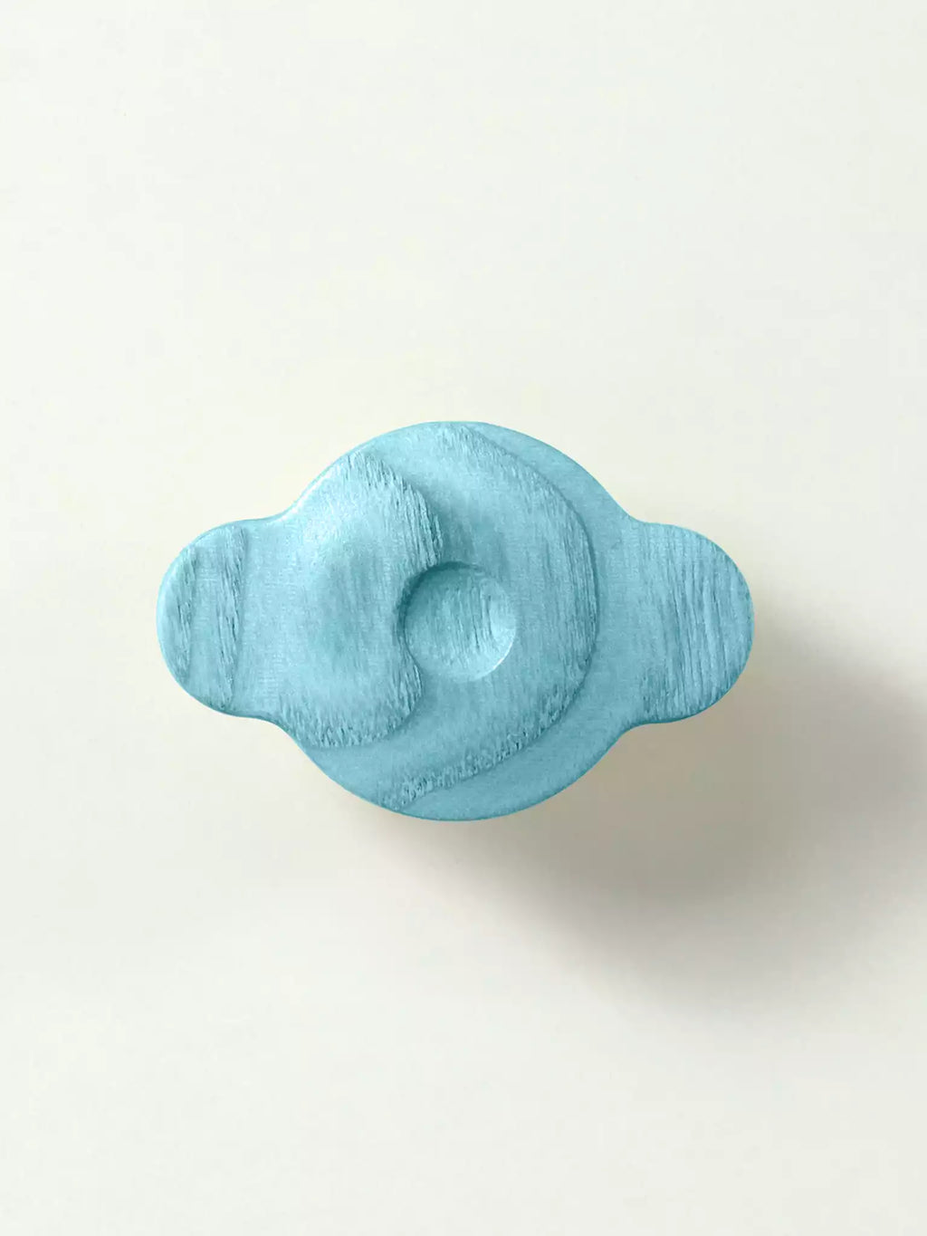 Light blue wooden knob on a white background
