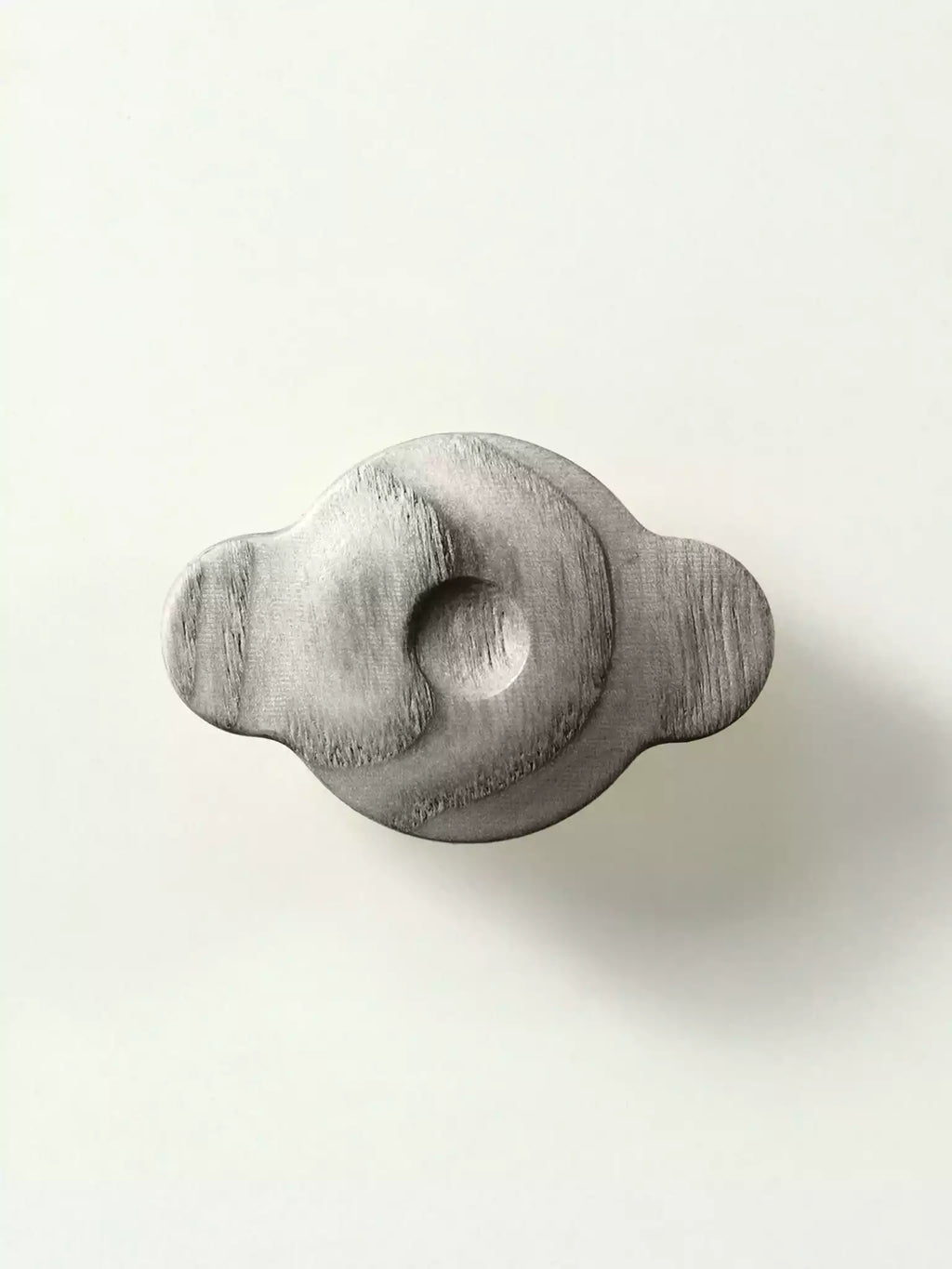 Cloud-shaped wooden furniture handle with natural wood grain

