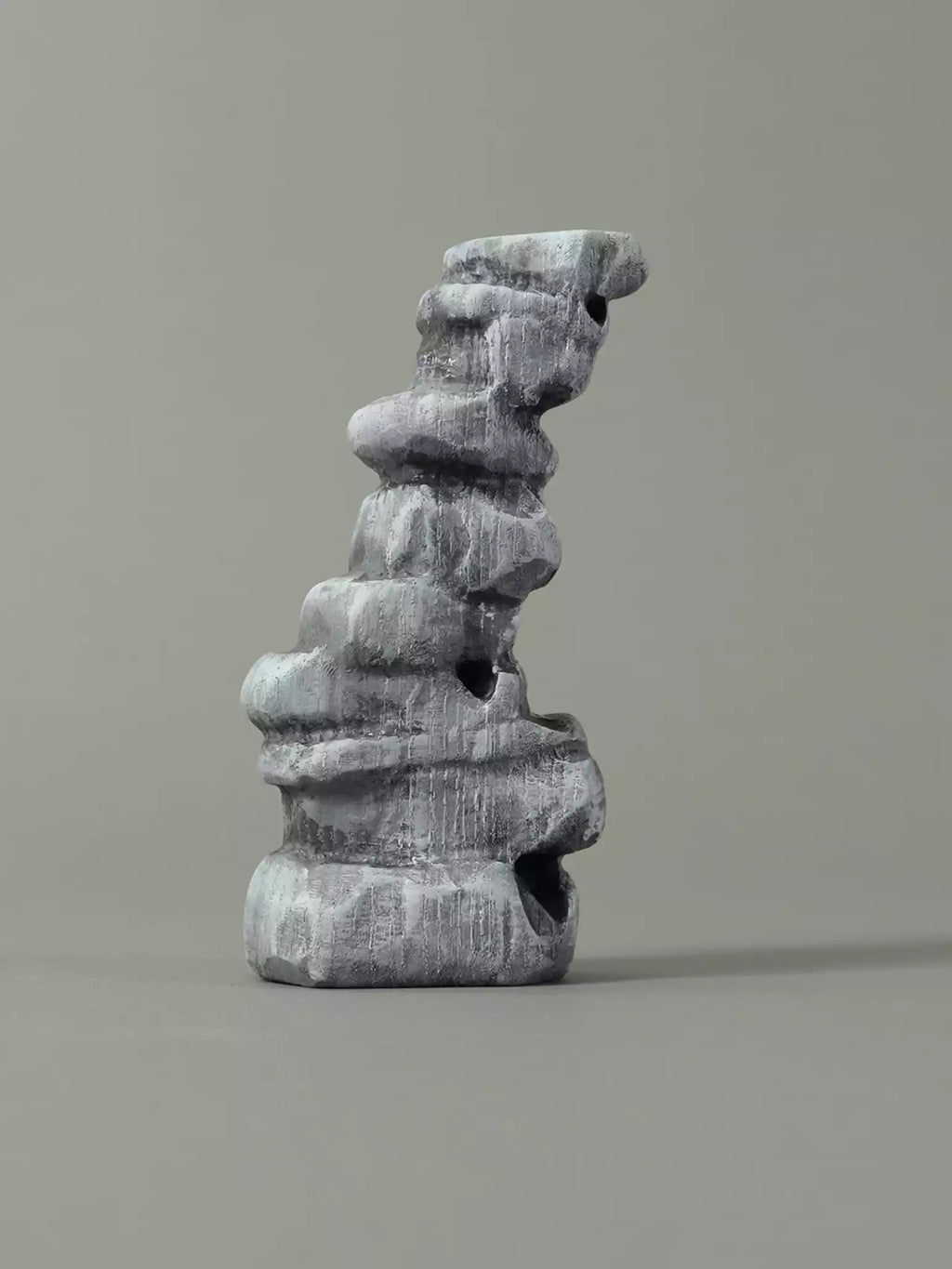 Gray stone sculpture on a gray background