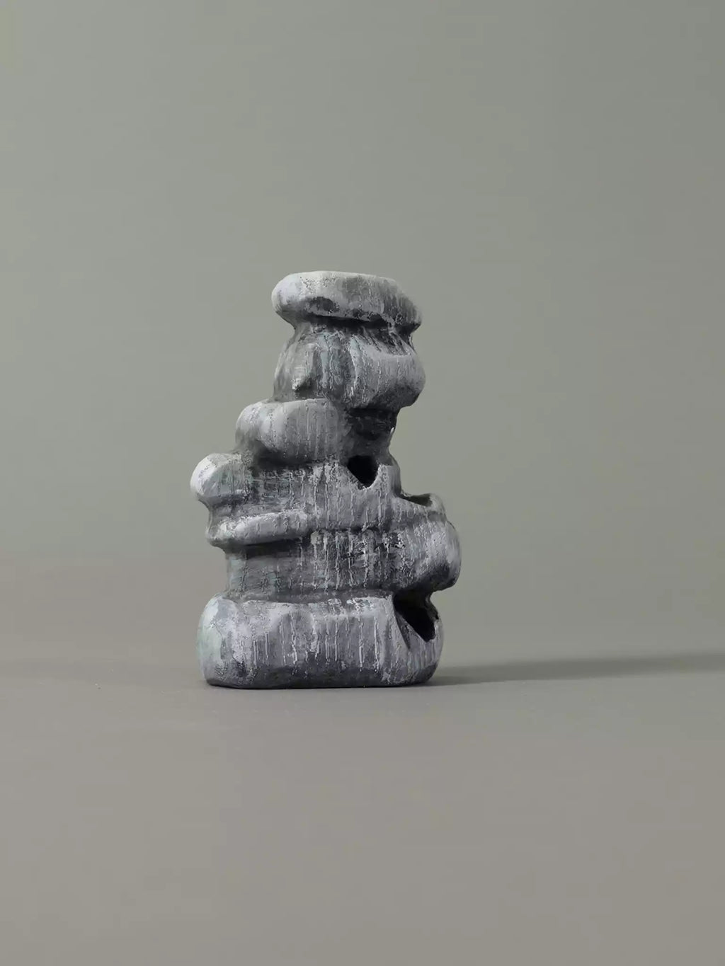 Stack of gray stone blocks on a plain background