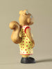 Wooden squirrel figurine in yellow dress with red dots