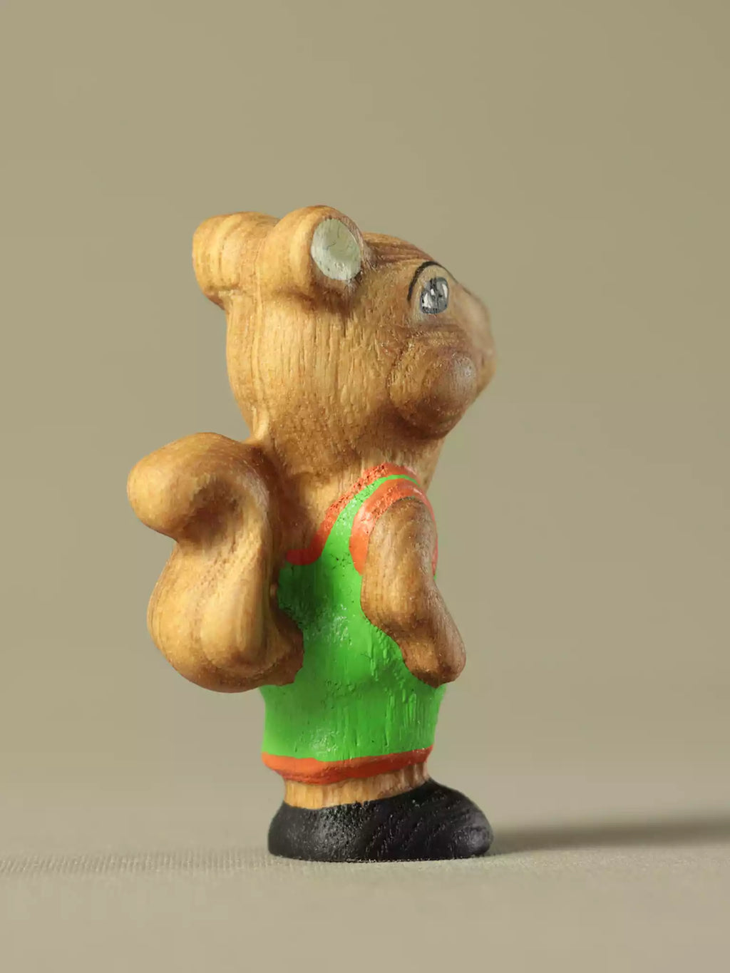 Montessori wooden squirrel toy with green shirt and natural wood finish