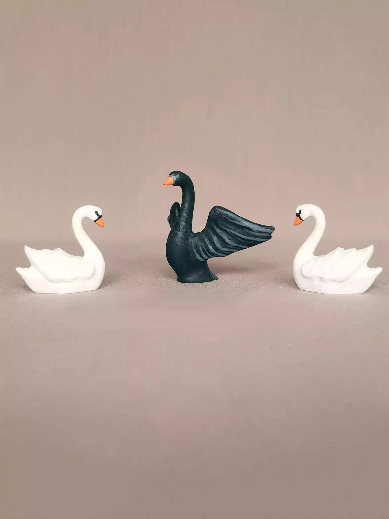 Wooden white and black swan figurines

