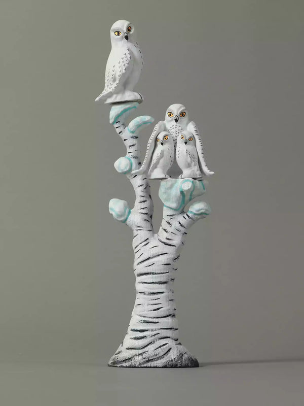 Wood sculpture of two owls on a branch  off Birch Tree against a gray background